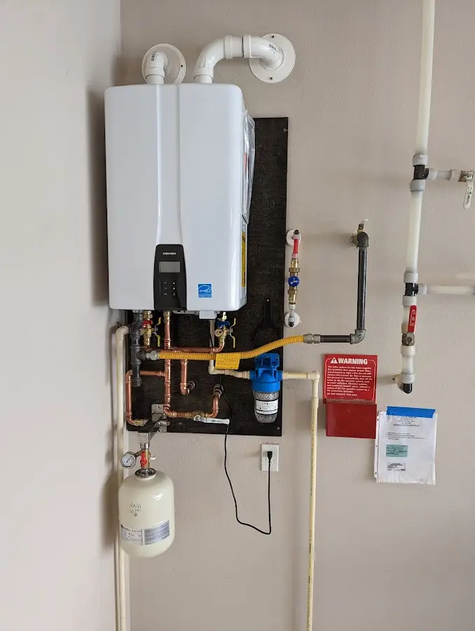 Professional plumber installing copper piping in a North Franklin home